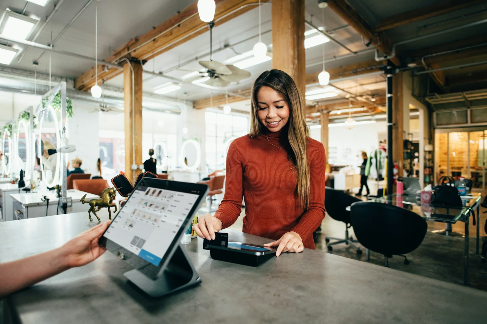 A small business front desk — a customer being served on a connected point-of-sale system